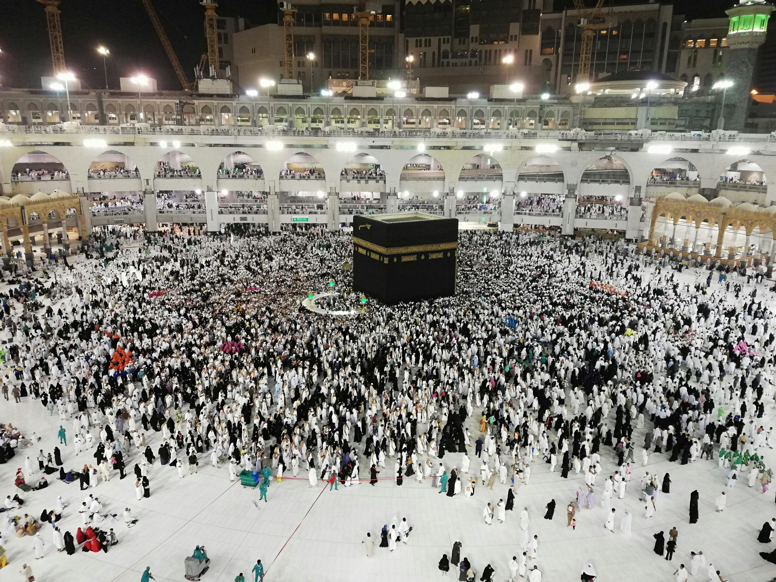 A beautiful composite image showing the Kaaba in Mecca with an airplane flying over a scenic travel destination, symbolizing Umrah, Hajj, and holiday travel